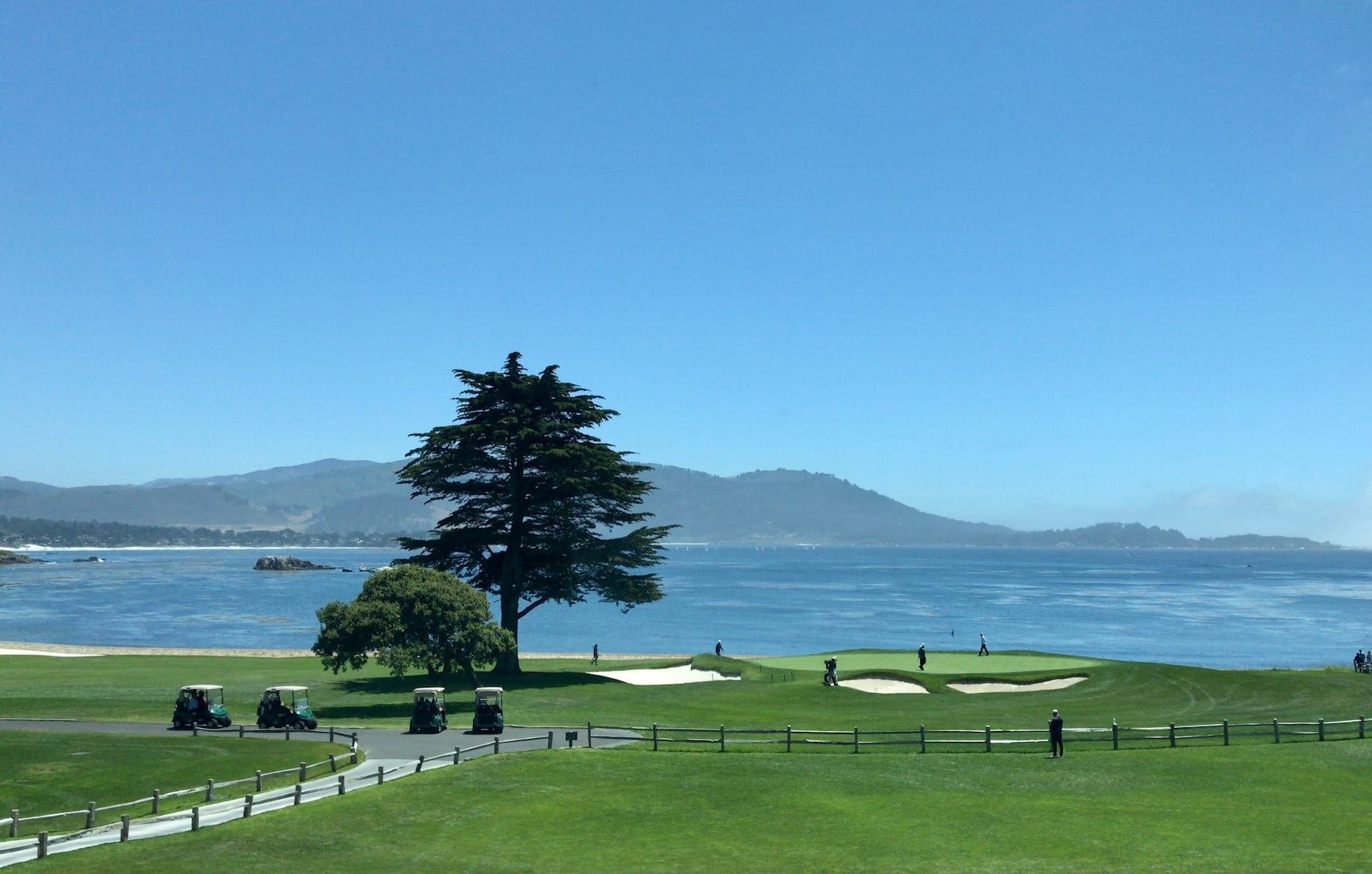 a view of a golf course with a lake in the background
